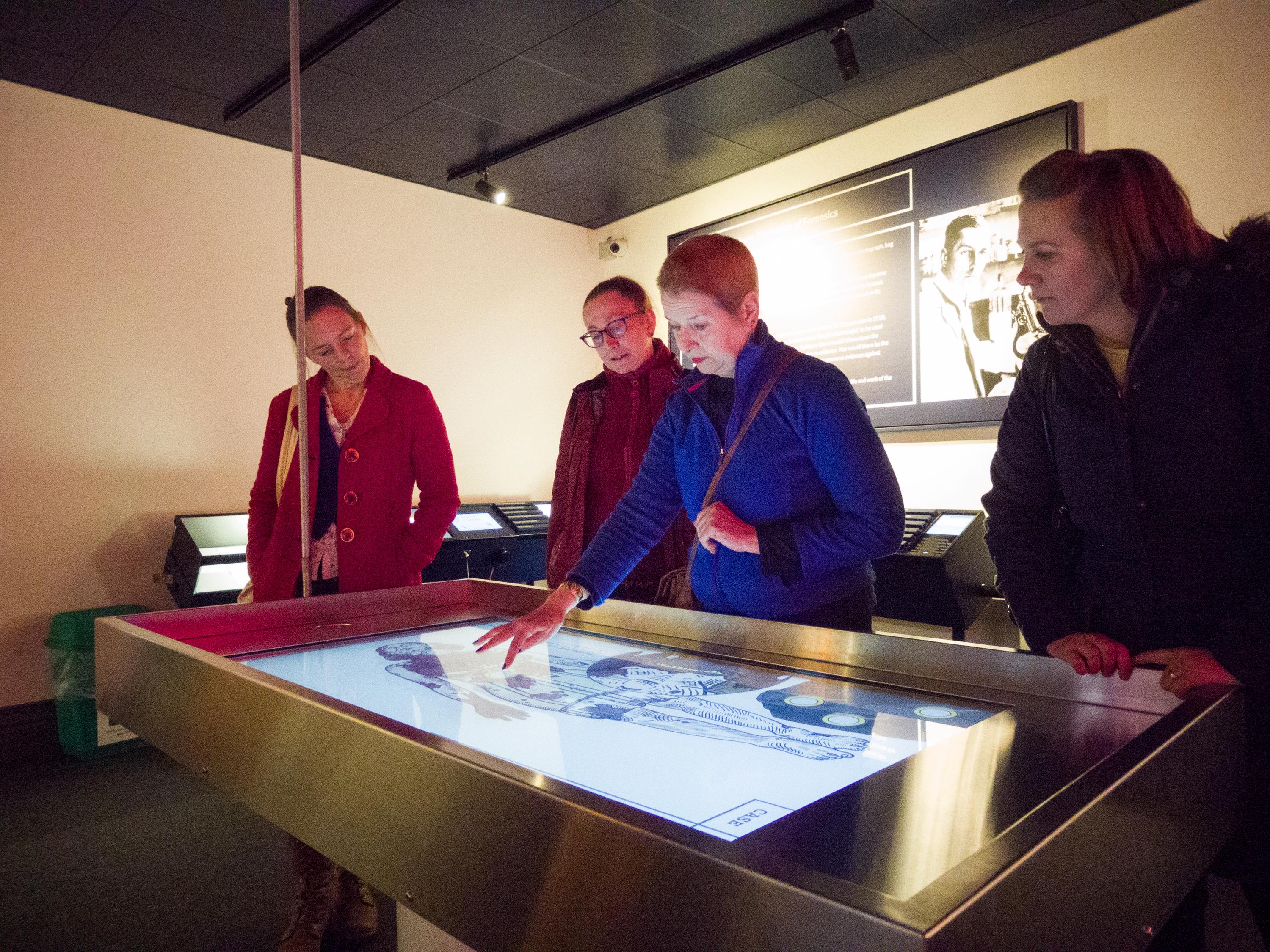 The Missing Persons team discuss plans for the garment autopsy with Dr Susan North (centre)