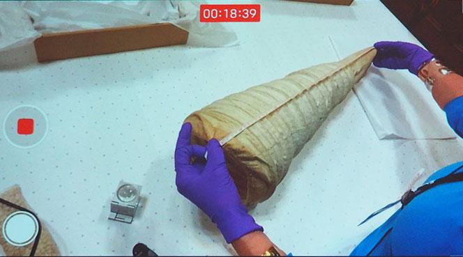 Dr Susan North getting to grips with the mystery garment in the historic courtroom as the autopsy commences